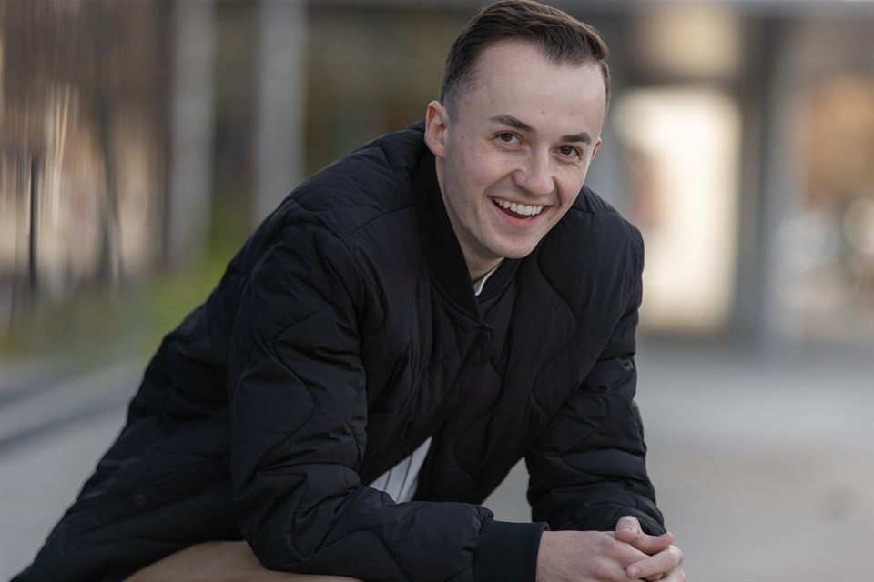 Van Taylor smiling in an outdoor portrait.